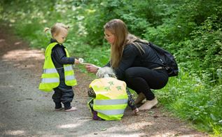 Pædagogisk assistent Karina Dalum med børn ude i skoven med bare fødder